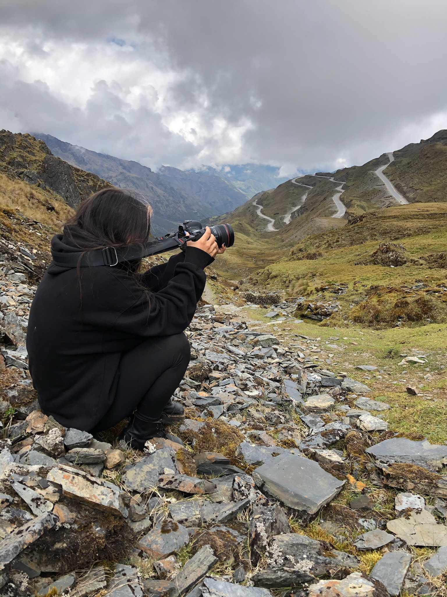 Student filming on rocky terrain, Peru